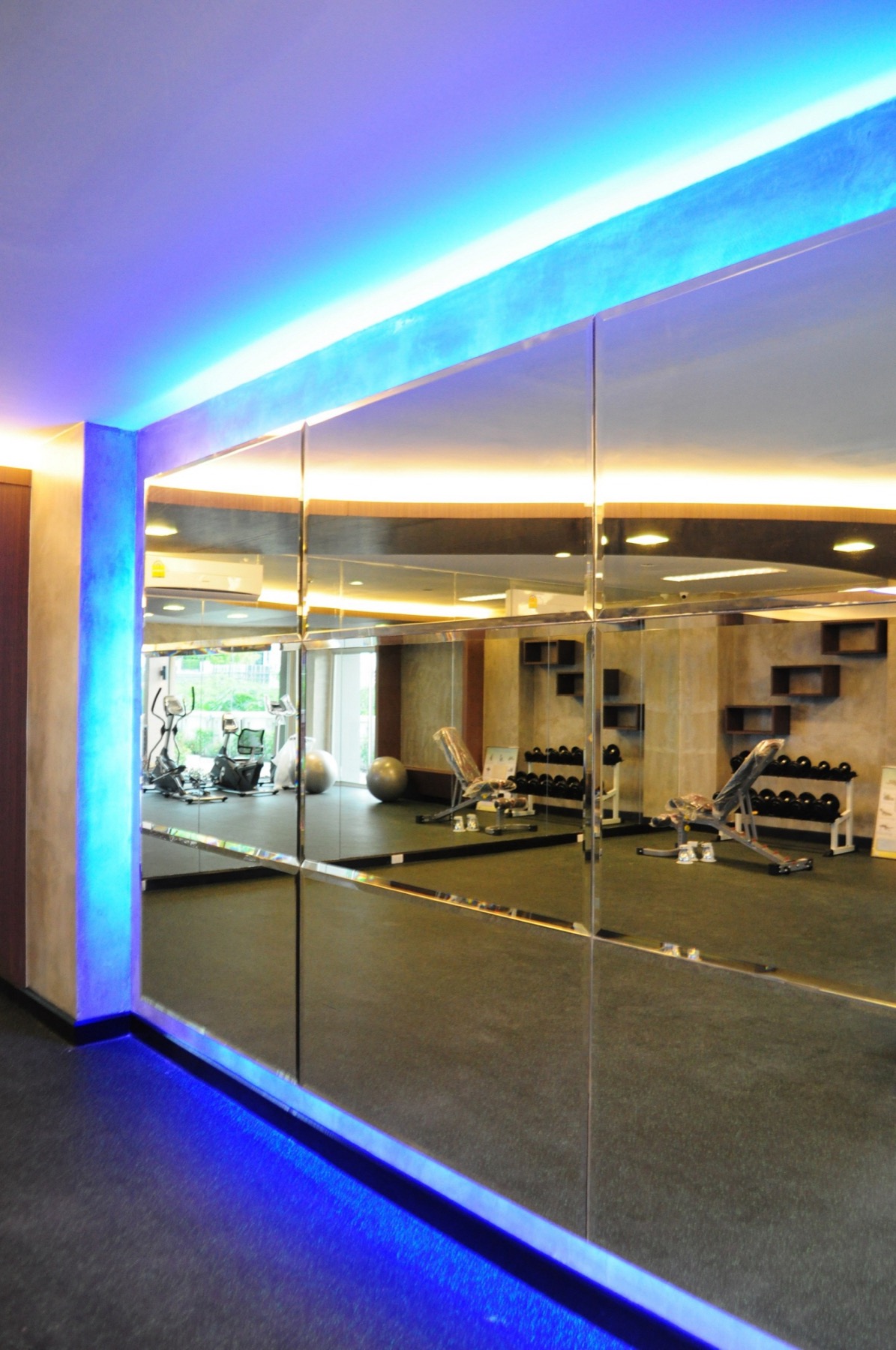 Full-height mirrors and training space inside the fitness room