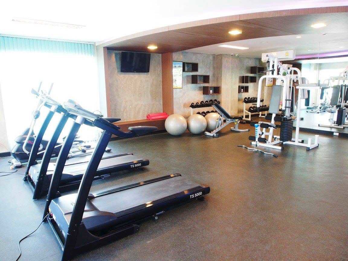 Fitness room with treadmills, weight equipment, and dumbbells