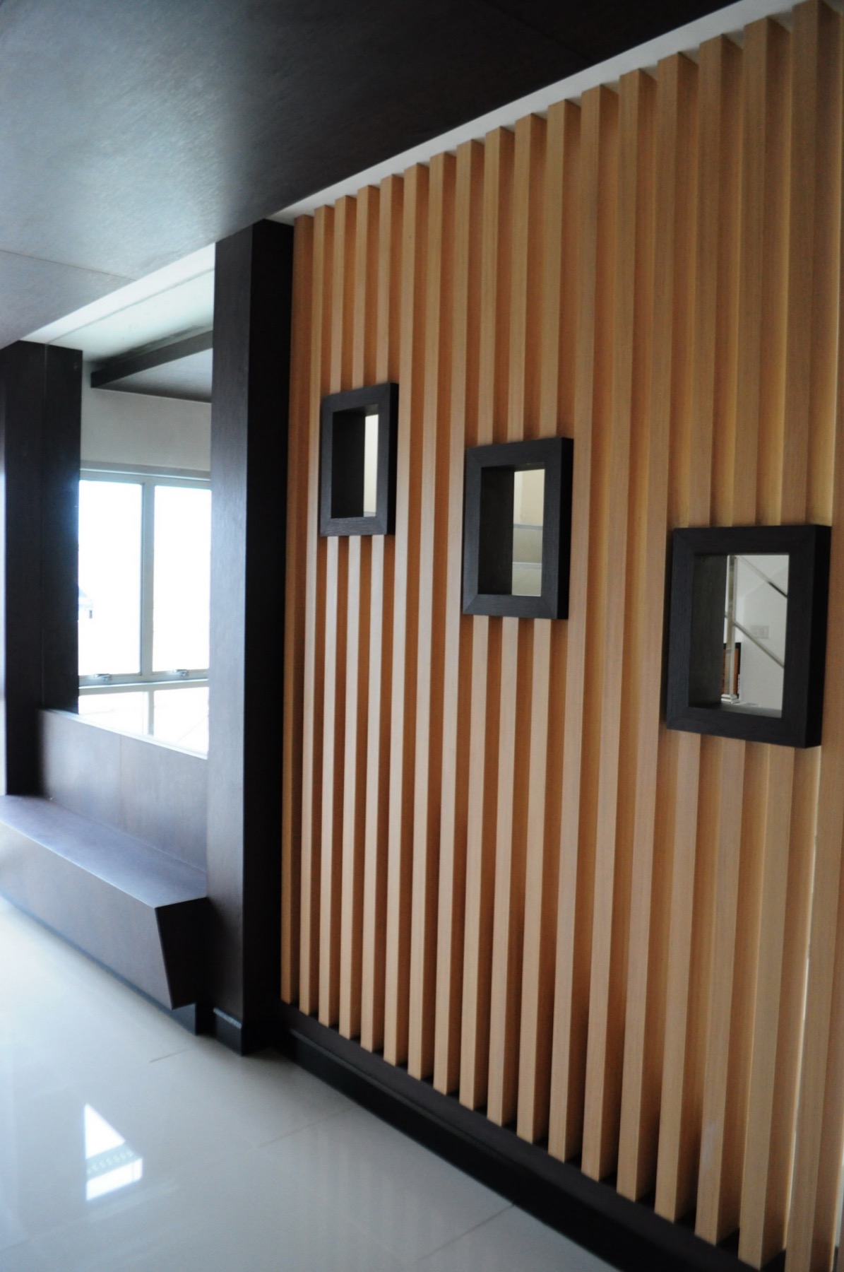 Wood-slat feature wall and built-in seating in the lift lobby