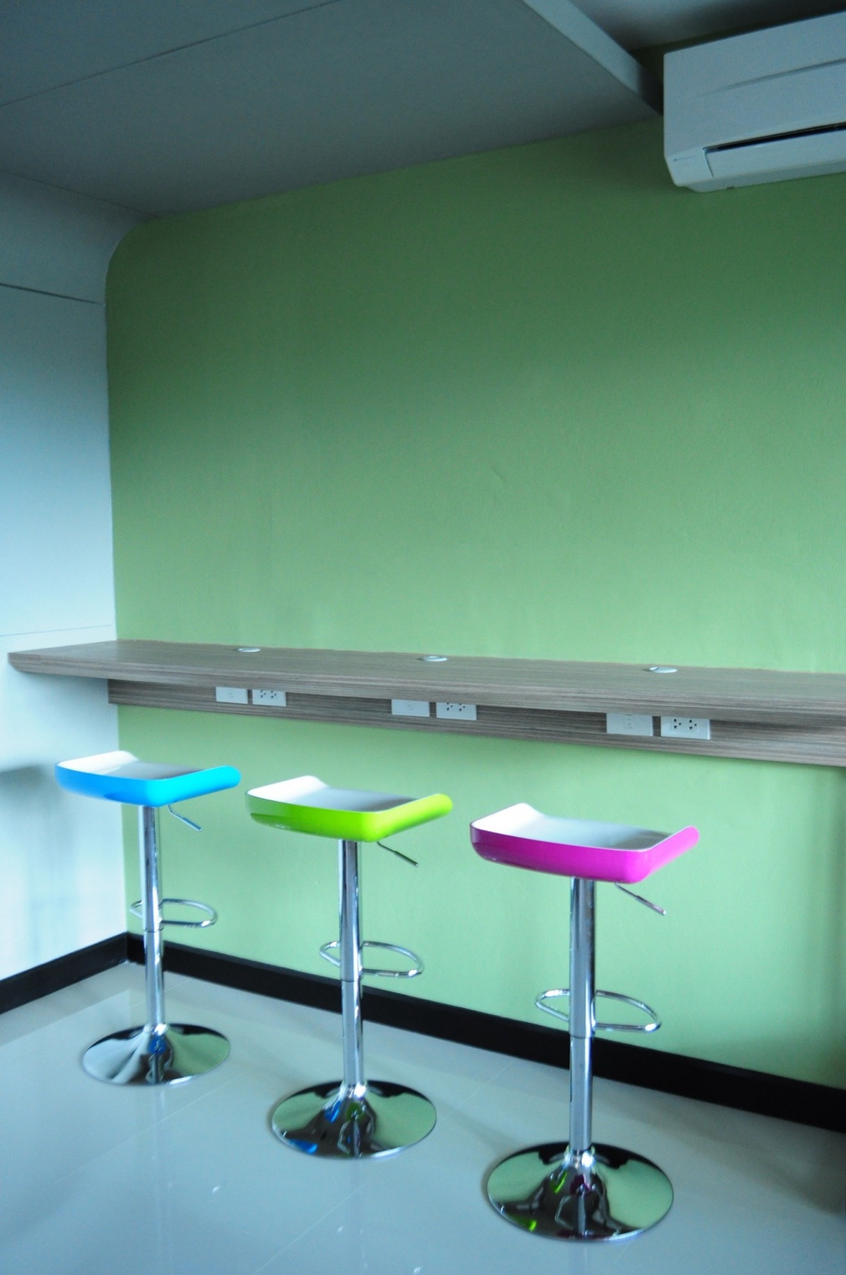 Study counter with power outlets and chairs inside the reading lounge