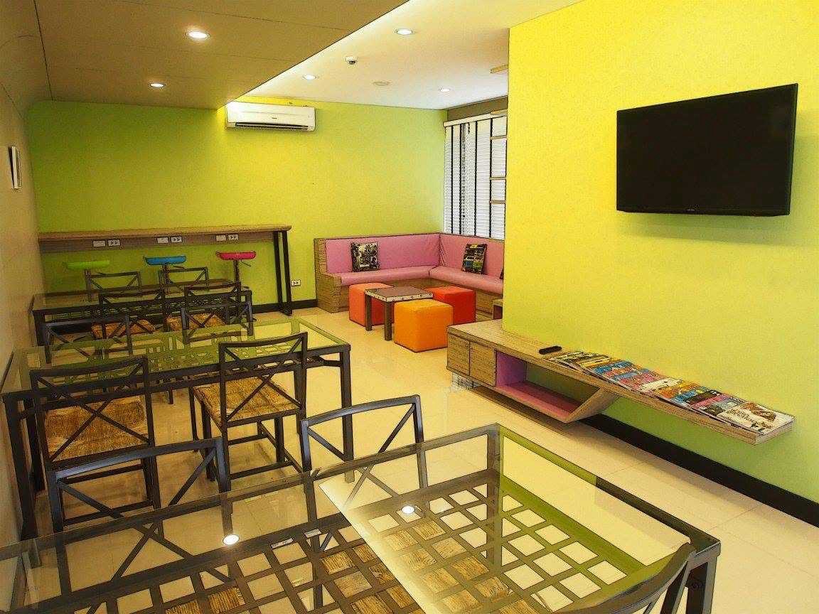 Reading lounge with tables, chairs, seating, and a television