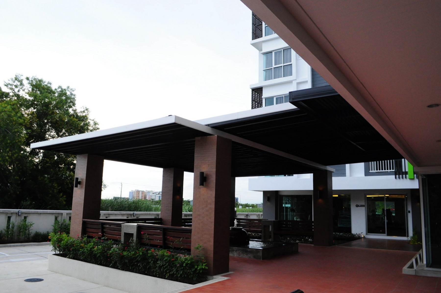 Walkway, garden, and covered relaxing area around the property