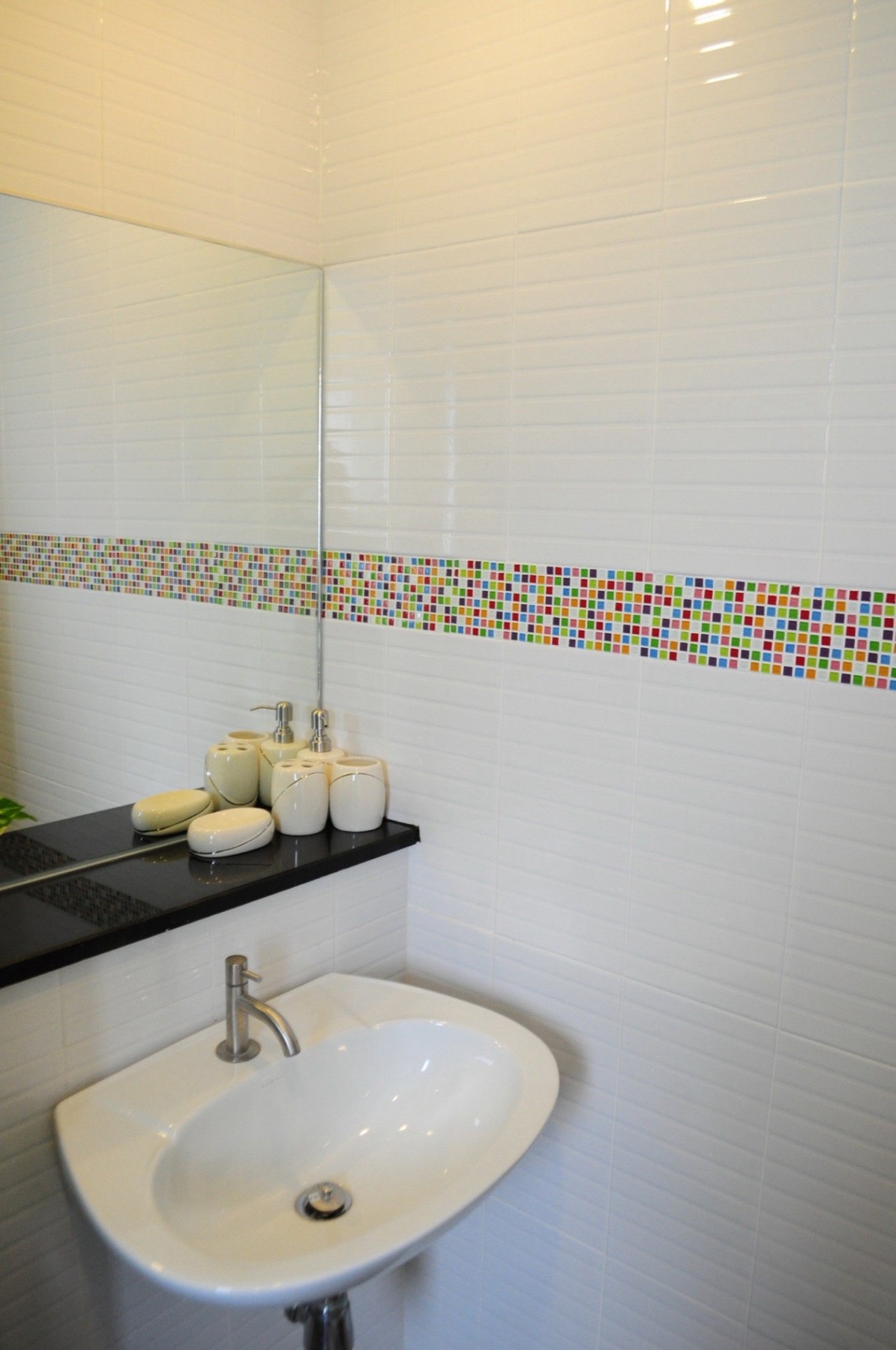 Washbasin and mirror in the Deluxe room's private bathroom