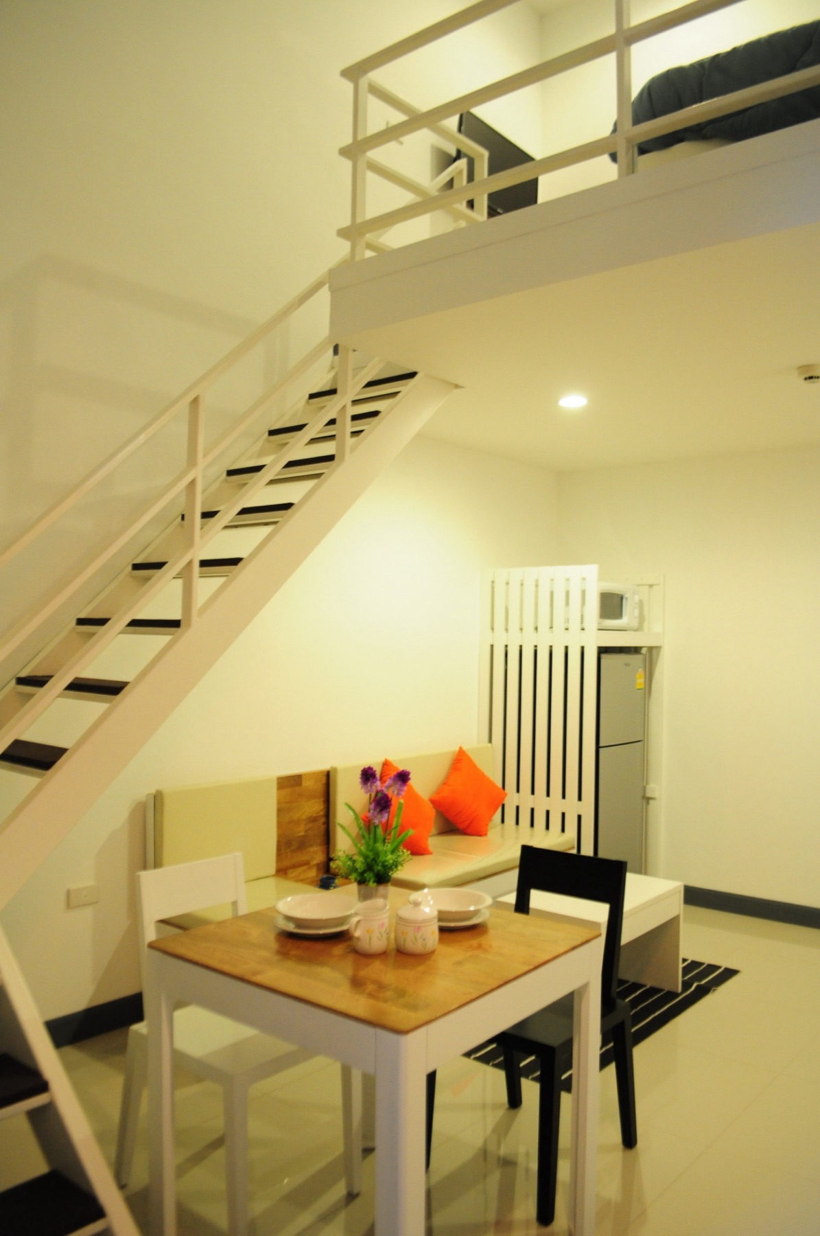 Double-height Loft layout with stairs, dining table, and seating area